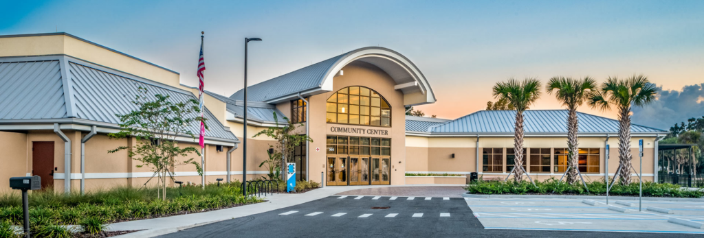 Wide shot of the entrance to the Palm Coast Community Center at 305 Palm Coast Parkway NE, venue for ScholarFest